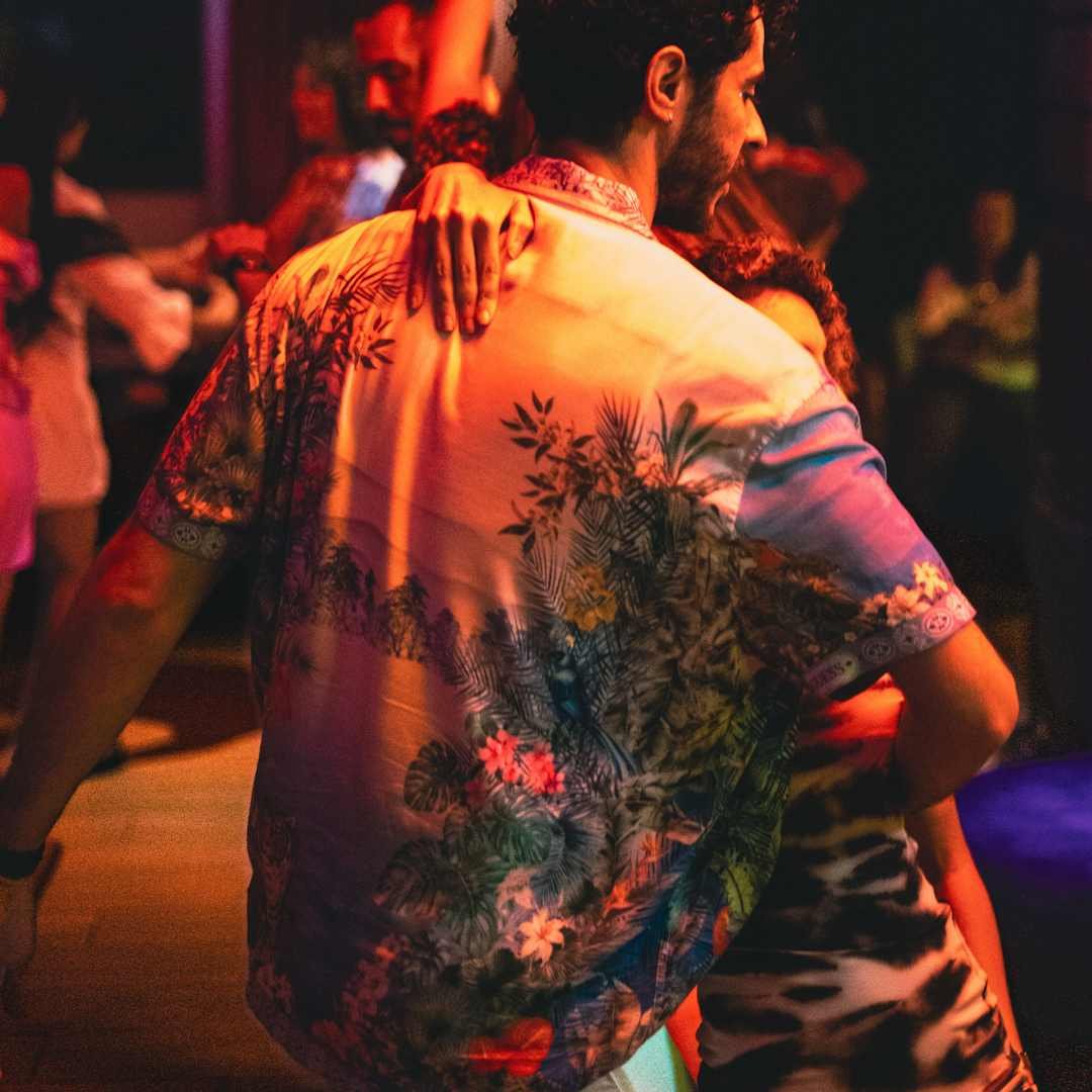 Couple dancing closely in a dim room for spicy replies to freaky spanish pick up lines