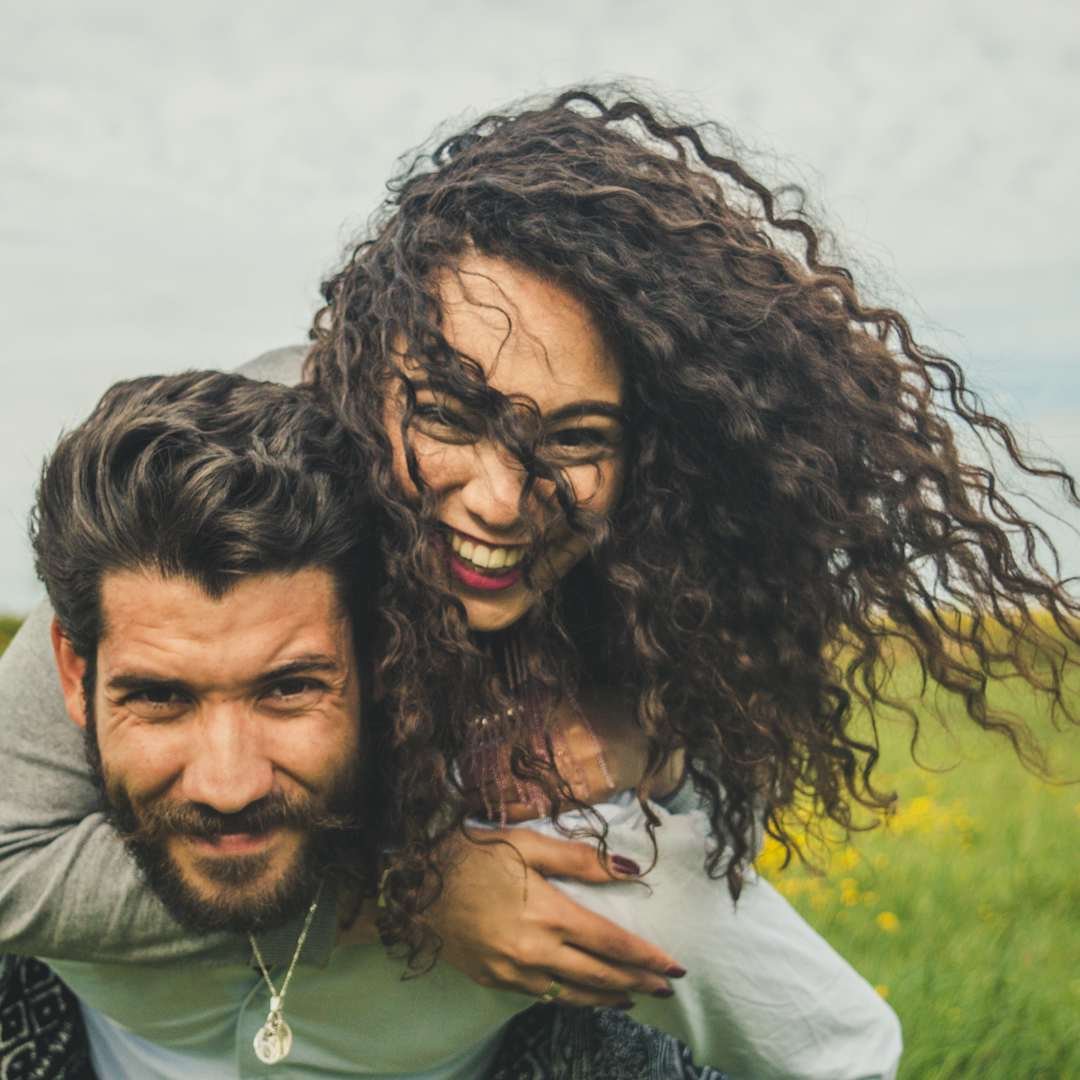Couple laughing outdoors for playful teasing freaky spanish pick up lines