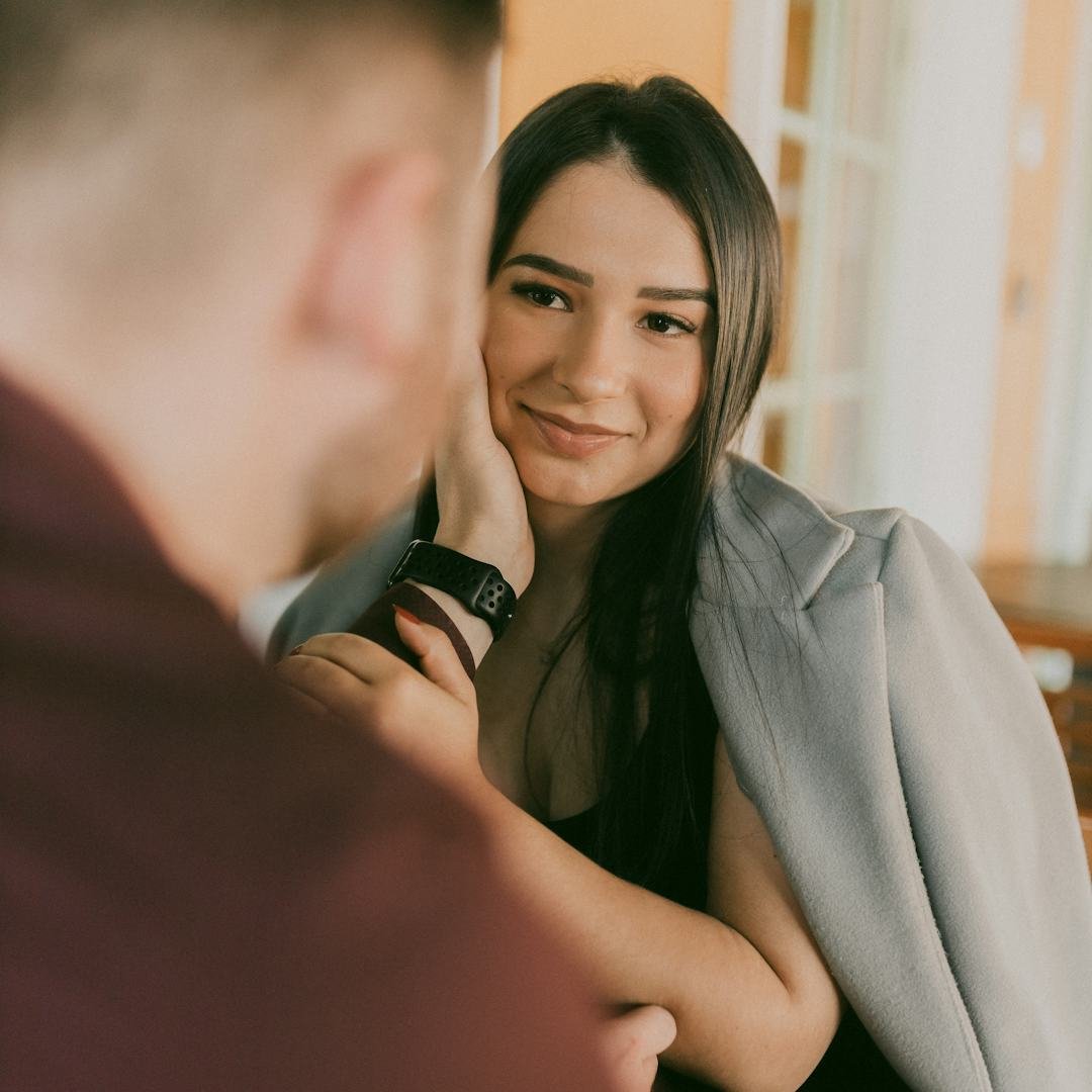 Woman smiling at a man at a piano for bold and confident spanish pick up lines